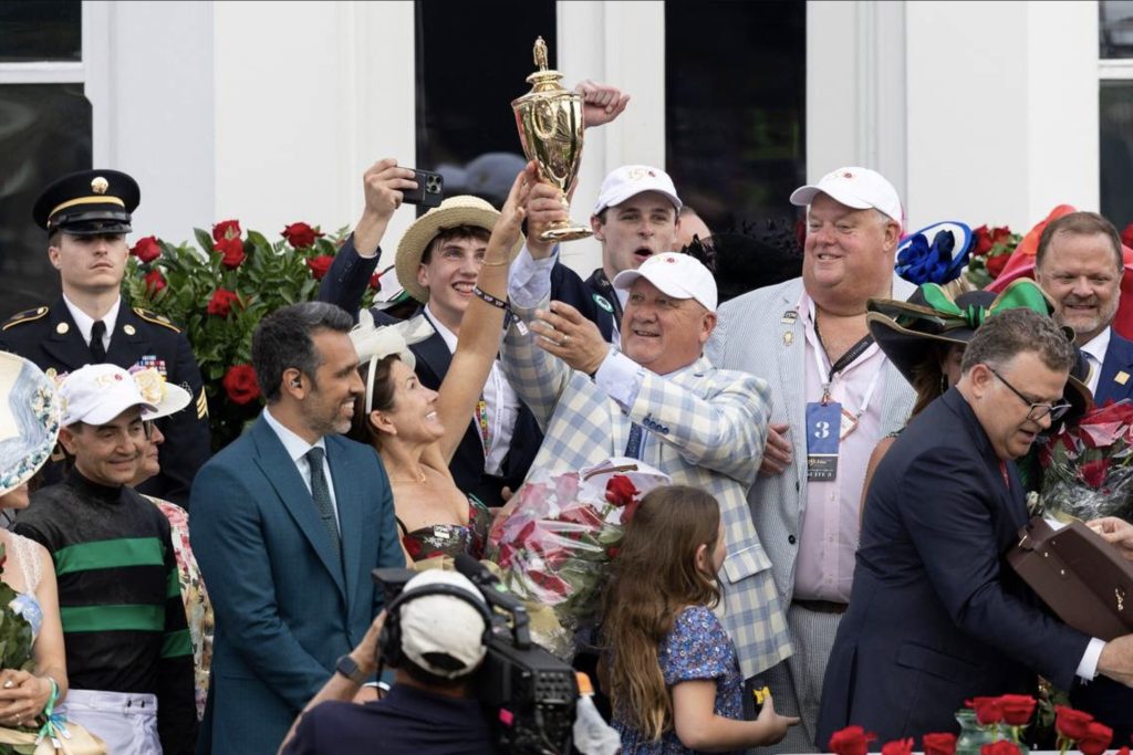 Kenny McPeek holding Kentucky Derby Trophy